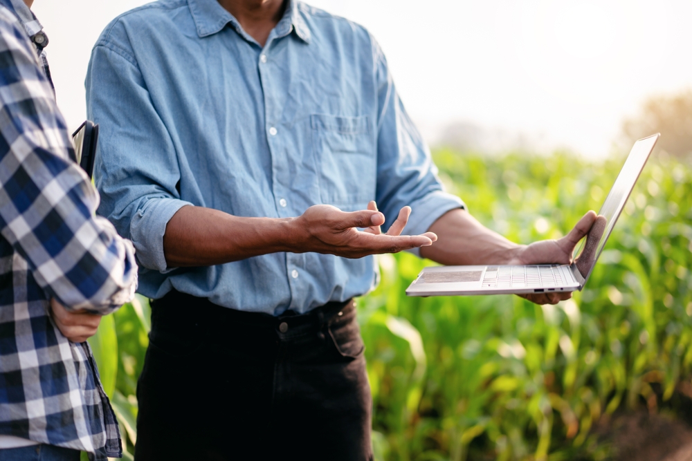 Two,Smart,Farmers,Using,Laptop,To,Examining,Quantity,And,Quality